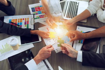 Teamwork of partners. Concept of integration and startup with puzzle pieces