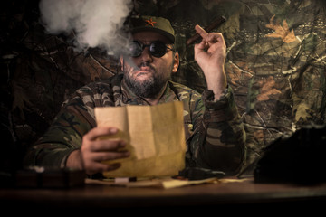 The evil dictator sitting on table. Angry communist general sitting at headquarter or Cuban...