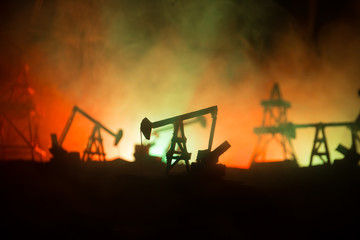 Wood Decoration. Oil pump oil rig energy industrial machine for petroleum in the sunset background...