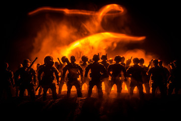Fototapeta premium Anti-riot police give signal to be ready. Government power concept. Police in action. Smoke on a dark background with lights. Blue red flashing sirens.