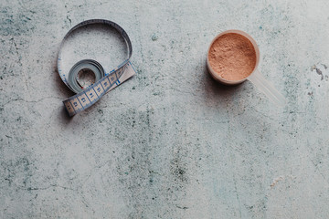 Whey protein scoop and measure tape with copy space