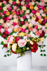 close up of summer bouquet of flowers in box or vase over colorful background