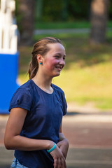 Portrait of teen girl on playground in summer park.