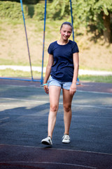 Fototapeta na wymiar Portrait of teen girl on playground in summer park.