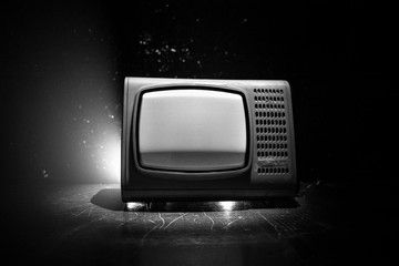 Old vintage red TV with white noise on dark toned foggy background. Retro old Television reciever no signal