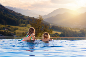 Family in swimming pool with mountain view