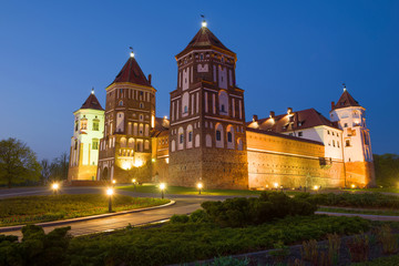 The old Mir Castle in the night illumination on April evening. Mir, Belarus