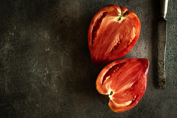 Halved Organic Red Bull's Heart Heirloom Tomato on Rustic Dark Background. Superfood Healthy Eating Concept. - 268625699