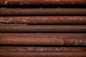 Rusty pipes. Corroded pipes lying parallel. Metal pipes.