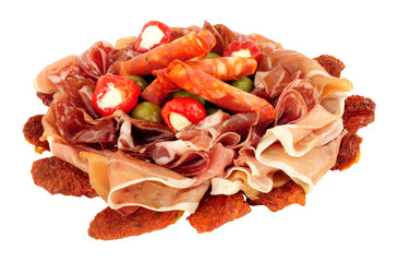 Gran antipasto snack selection with salami and cured meat slices isolated on a white background