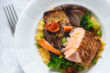 Roasted Salmon Fillet with Vegetables on Rustic White Plate. Healthy Food Concept.