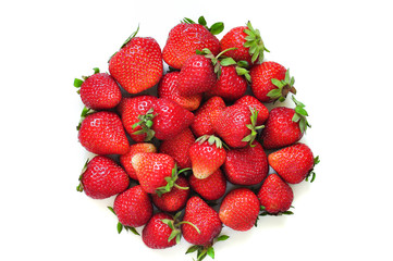 A lot of strawberry berries on a white background. A group of sweet fruits. Vitamin fruits for smoothies, cocktails and preserves. Natural products for healthy nutrition for vegetarians.