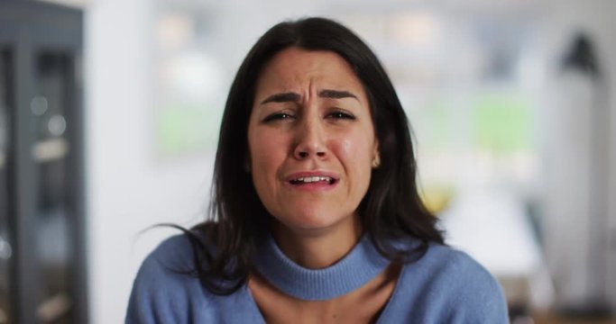 4K Close up of unhappy emotional woman looking at camera & crying. Slow motion.