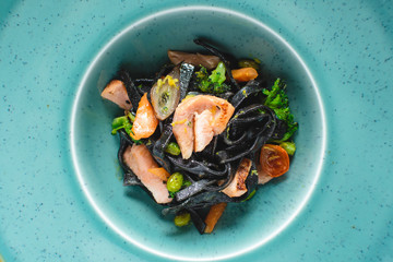 Black Pasta Tagliatelle from Squid Ink with Salmon and Vegetables