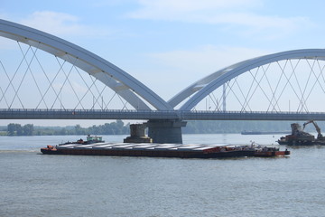 Fototapeta na wymiar Barges under Zezelj bridge on Danube