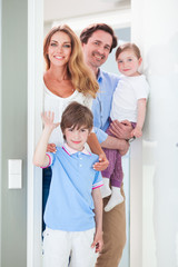 Fototapeta na wymiar Happy family in doorway