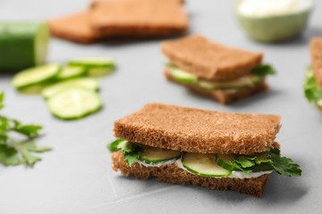 Traditional English cucumber sandwiches on grey table