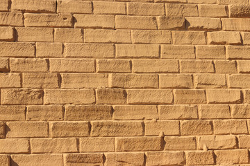 Yellow sandstone brick wall textured background
