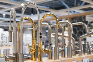 showcase in the store with faucets for the kitchen and bathroom