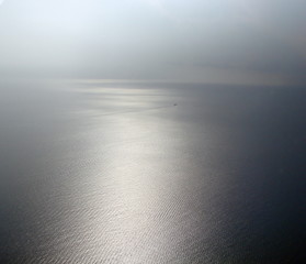 A charming picture of the infinite surface of the Mediterranean Sea with the glowing sunlight, a...