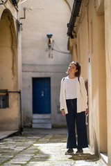 handsome tourist girl visiting narrow streets of old town in southern Italy, Basilicata Apulia region