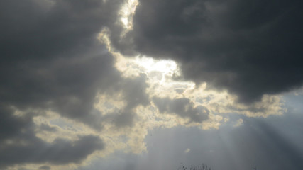 Drammatic photo of cloudy sky after the storm with bright light rays