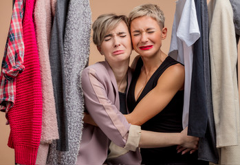 Obraz premium sad beautiful young women are crying while shopping. emotional prizes, sales.unhappy hugging girls have missed Black Friday