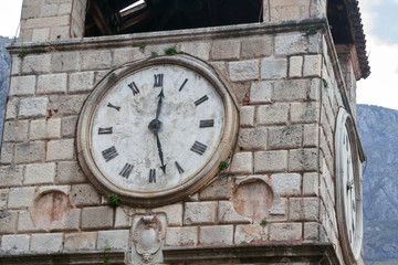 Fototapeta na wymiar lose up of the Clock on the Tower on the Square of Arms. Kotor, Montenegro