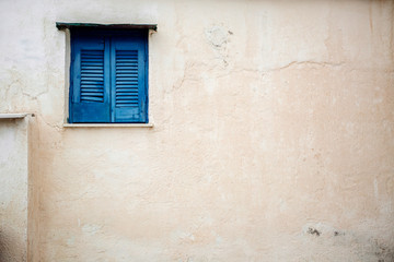 Fototapeta na wymiar Blue window on white wall
