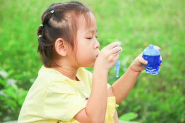 Asian girls are playing blowing bubbles into balloons in parks in Thailand.