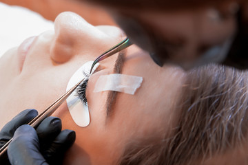 Eyelash Extension Procedure. Woman Eye with Long Eyelashes. Lashes, close up, macro, selective focus