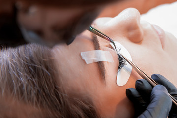 Eyelash Extension Procedure. Woman Eye with Long Eyelashes. Lashes, close up, macro, selective focus