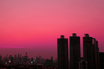 Silhouette of skyscrapers Against Evening Sky in Vibrant Pink Gradation 