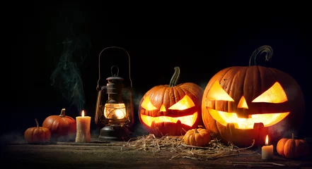 Foto auf Glas Halloween pumpkin head jack lantern with burning candles © Alexander Raths