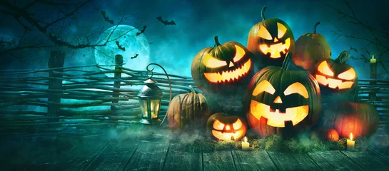 Muurstickers Halloween pumpkin head jack lantern with burning candles © Alexander Raths