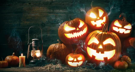 Zelfklevend Fotobehang Halloween pumpkin head jack lantern with burning candles © Alexander Raths