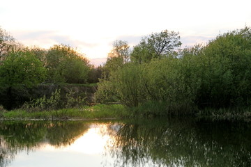 Fototapeta na wymiar In the evening on the river. Beautiful sunset