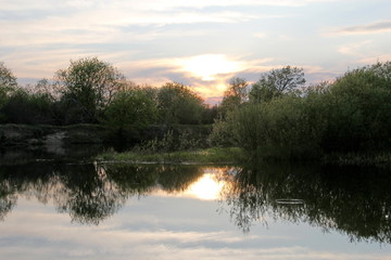 Fototapeta na wymiar Orange sunset over the river