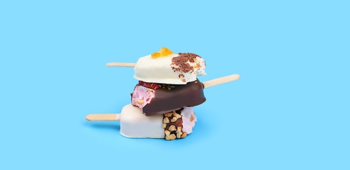 eskimo ice cream in chocolate glaze. tasty sweet treat, different kind of ice cream. Composition with delicious ice-cream on blue background. Close up, copy space