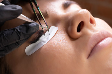 Eyelash Extension Procedure. Woman Eye with Long Eyelashes. Lashes, close up, macro, selective focus