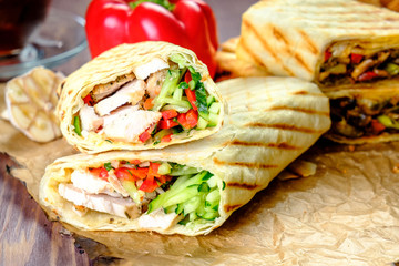 roast meat with vegetables on old paper in lavash