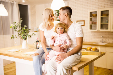 beautiful family dad mom and daughter have fun in a apartment