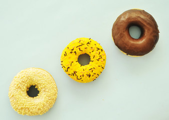 Delicious donuts on light pastel color background. National Donut Day concept.