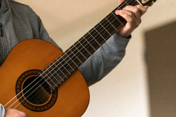Fototapeta premium Young musician with wooden guitar