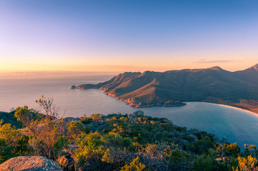 Sunrise landscape of ocean coastline with mountains and beach