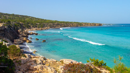 Cyprus coastline. Sea rocky beach in Cyprus on sunny clear day. Sea shore landscape with turquoise water