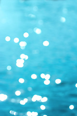 Seawater in sunlight. The photo is in the defocus. Summer background.