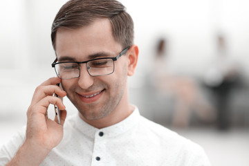 close up.smiling businessman talking on his smartphone