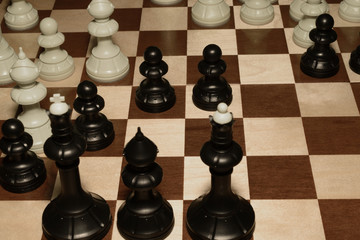 Chessboard under white pieces for strategy concept