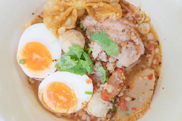 Noodle tom yum with pork and egg .